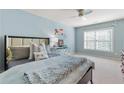 Comfortable bedroom with light blue walls, a ceiling fan, and lots of natural light at 2906 Ansley Manor Ct, Marietta, GA 30062