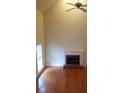 Open living room with hardwood floors, brick fireplace, high ceilings and large windows at 3416 N Cook Rd, Powder Springs, GA 30127