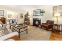 Inviting living room featuring hardwood floors, a cozy fireplace, and tasteful decor at 825 Loridans Ne Cir, Atlanta, GA 30342