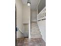 Foyer with tiled floor that lead to carpeted stairs and white railings at 832 Wyntuck Nw Dr, Kennesaw, GA 30152