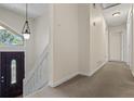 Hallway with carpet floors, neutral walls and white trims, plus a front door on the left at 832 Wyntuck Nw Dr, Kennesaw, GA 30152