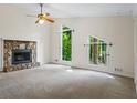 Spacious living room with a stone fireplace and large windows at 832 Wyntuck Nw Dr, Kennesaw, GA 30152