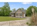 Side view of a charming home with a front porch, complemented by well-maintained landscaping and an inviting driveway at 109 J O Simmons Path, Douglasville, GA 30134