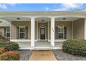 Inviting front porch with classic white columns, landscaping, and stylish front door at 109 J O Simmons Path, Douglasville, GA 30134