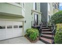 Welcoming entrance featuring a curved staircase, tiled steps, wrought iron railings, and a well-manicured garden bed at 27 Sycamore Sta, Decatur, GA 30030