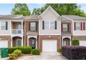 Charming townhome featuring brick accents, neutral siding, and a one-car garage at 2826 Snapfinger Mnr, Decatur, GA 30035