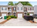 Attractive brick and siding townhome with a driveway and well-maintained landscaping at 2826 Snapfinger Mnr, Decatur, GA 30035
