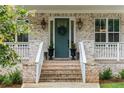 Welcoming front porch featuring a decorative wreath, stylish lighting, and elegant planters at 425 Harold Ne Ave, Atlanta, GA 30307