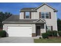 Two-story home features a two car garage, neutral siding, and a welcoming entrance at 6069 Semaphore Rdg, Rex, GA 30273