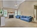 Bright living room with a fireplace, vaulted ceiling, and large windows providing natural light at 1593 Fredricksberg Dr, Loganville, GA 30052