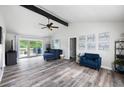 Bright living room with vaulted ceiling, exposed beam, modern furniture, and sliding door to the deck at 2103 Blue Creek Ct, Conley, GA 30288