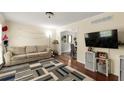 Cozy living room with hardwood floors, a comfortable sofa, and a flat-screen TV at 2910 Edwards Ct, Marietta, GA 30068