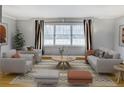 Bright living room featuring neutral furniture, large windows, and stylish decor at 3519 Sunderland Ne Way, Brookhaven, GA 30319