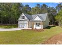 Newly built home featuring a pristine lawn, attached garage, and inviting exterior design at 1488 Campbell Rd, Covington, GA 30014