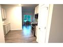 Stylish kitchen with stainless steel oven, microwave and white cabinets at 710 Park Place Trl, Social Circle, GA 30025