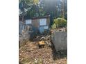 Backyard features concrete walls, storage space, and natural foliage, offering space for landscaping and outdoor activities at 2066 Bethel Nw Dr, Atlanta, GA 30314