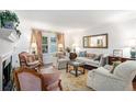 Bright and airy living room with plush seating, hardwood floors, and a decorative fireplace at 170 Elysian Nw Way, Atlanta, GA 30327