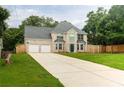 Inviting two-story house with a well-kept lawn, double garage, and a spacious driveway at 1976 Glen Echo Dr, Decatur, GA 30032