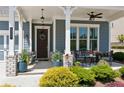 Cozy front porch with seating area, decorative plants, and charming details like hanging lights and wreath at 4207 N Carver Dr, Atlanta, GA 30360