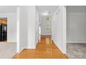 Inviting foyer with hardwood floors transitioning to carpeted rooms and bright white walls at 6131 Windflower Dr, Powder Springs, GA 30127