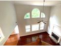 Spacious living room featuring a fireplace, hardwood floors, vaulted ceiling, and lots of windows at 6131 Windflower Dr, Powder Springs, GA 30127