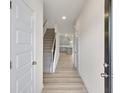 Inviting entryway with hardwood floors, staircase, and view of the kitchen at 1215 Elowen Dr, Austell, GA 30168