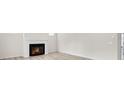 Bright living room features a modern fireplace and hardwood flooring at 1215 Elowen Dr, Austell, GA 30168