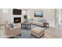 Staged living room showcasing a cozy fireplace, plush seating, and a stylish area rug at 1215 Elowen Dr, Austell, GA 30168