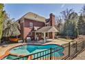 Relaxing backyard featuring a private pool, patio space, and mature landscaping at 389 Mill Creek Ne Bnd, Atlanta, GA 30307
