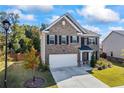 Charming two-story home with a brick facade, well-maintained landscaping, and a two-car garage at 529 Azalea Bloom Dr, Loganville, GA 30052