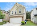 Charming home featuring a two-car garage, traditional architectural details, and well-maintained landscaping at 6454 Grey Fox Way, Riverdale, GA 30296