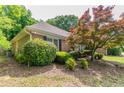 A view of the rear exterior of the property shows mature landscaping and healthy lawn at 2950 Camary Place Se Dr, Conyers, GA 30094