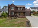 Attractive two-story home with landscaped front yard, stone facade, and attached garage at 893 Sandune Dr, Norcross, GA 30093