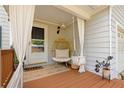 Cozy front porch with curtains, egg chair swing, and stylish decor at 1025 Taylor Oaks Dr, Roswell, GA 30076