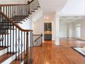 Elegant staircase featuring wrought iron details, hardwood floors, and views of the living space at 310 Anders Path, Marietta, GA 30064
