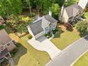 An aerial shot showcasing the home's landscaped yard and neighborhood setting, with mature trees at 1126 Gate Post Ct, Powder Springs, GA 30127