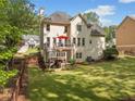 A well maintained home with a deck, stairs to the yard, and a manicured lawn at 1126 Gate Post Ct, Powder Springs, GA 30127