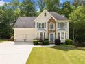 Charming two-story home with a well-kept lawn, stone detail, and an attached two-car garage at 1126 Gate Post Ct, Powder Springs, GA 30127