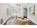 Bright living room features built-in shelving, a ceiling fan, and French doors to the outside at 1281 Snapfinger Rd, Decatur, GA 30032
