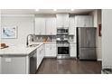 Well-lit kitchen featuring stainless steel appliances, white cabinets, and granite countertops at 2450 Norwood Park Xing, Atlanta, GA 30340