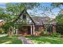 Inviting two-story home with lush landscaping, a stone walkway, and a cozy front porch at 26 Clarendon Ave, Avondale Estates, GA 30002
