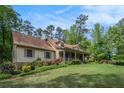Inviting home exterior with a covered porch, stone accents, and beautiful landscaping at 351 Old Orchard Ct, Marietta, GA 30068