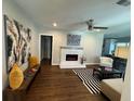 Open-concept living room boasting modern decor, a cozy fireplace, and elegant hardwood floors at 1740 Emerald Ave Ave, Atlanta, GA 30310