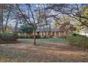 Charming single-story home with mature trees and a well-maintained lawn at 3226 Custer Lake Nw Dr, Marietta, GA 30064