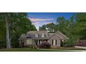 Traditional brick home with dormer windows, dark shutters, and a well-maintained lawn at 3445 Strawberry Ln, Cumming, GA 30041