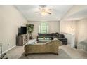 Bright living room with neutral walls, plush chaise lounge, comfortable grey sofa and staircase to another level at 300 Alcovy Way, Covington, GA 30014