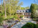 Charming brick home featuring a manicured lawn, beautiful landscaping and a private two-car garage at 4584 E Conway Nw Dr, Atlanta, GA 30327