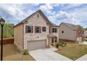 Attractive two-story home showcasing a brick exterior, attached garage, and well-maintained lawn at 509 Azalea Bloom Dr, Loganville, GA 30052