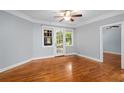 Bright living room featuring hardwood floors, a ceiling fan, and large windows bringing in natural light at 677 Somerset Ne Ter # C6, Atlanta, GA 30306