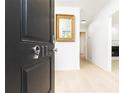 Bright entryway featuring a modern light wood floor, and a gold trimmed mirror at 911 Lenox Hill Ne Ct, Atlanta, GA 30324